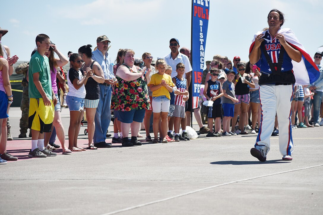 Mark Kirsch, strongman and entertainer, makes his way to pull a Transport Erector missile maintenance truck July 13, 2019, at the “Mission Over Malmstrom” open house event on Malmstrom Air Force Base, Mont.