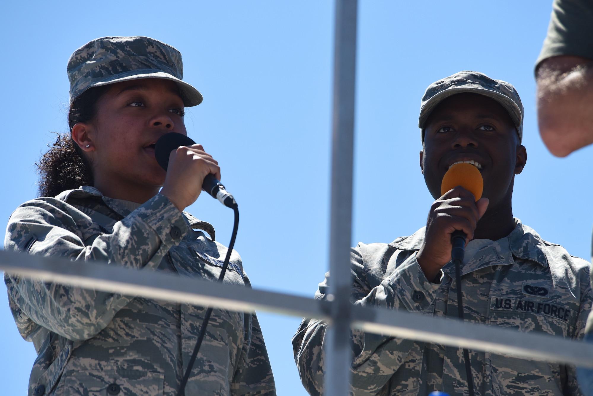 Airman 1st Class Chiyanna White, 341st Missile Wing public affairs broadcast journalist, left, and Staff Sgt. Ricardo Fredeling, 341st Civil Engineer Squadron Airman dorm leader, perform the National Anthem July 13, 2019, at the “Mission Over Malmstrom” open house event on Malmstrom Air Force Base, Mont