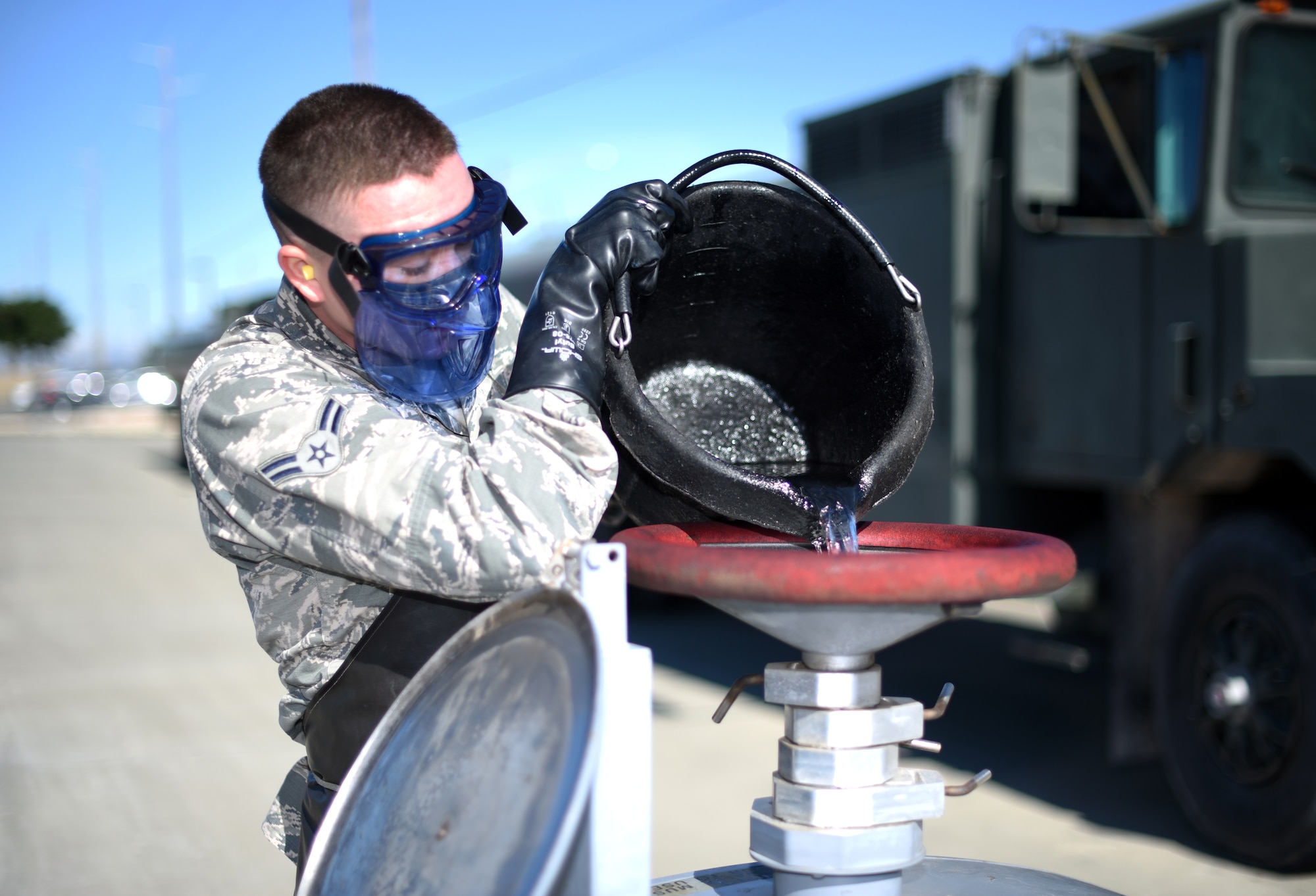 U.S. Air Force Airman 1st Class Matthew Melder, 60th Logistics Readiness Squadron fuels distribution operator, checks the quality of a fuel sample July 10, 2019, at Travis Air Force Base, California. The 60th LRS commits itself to putting the best fuel into Travis’ aircraft via a 128-point inspection that must be conducted on the fuel every day. (U.S. Air Force photo by Senior Airman Christian Conrad)