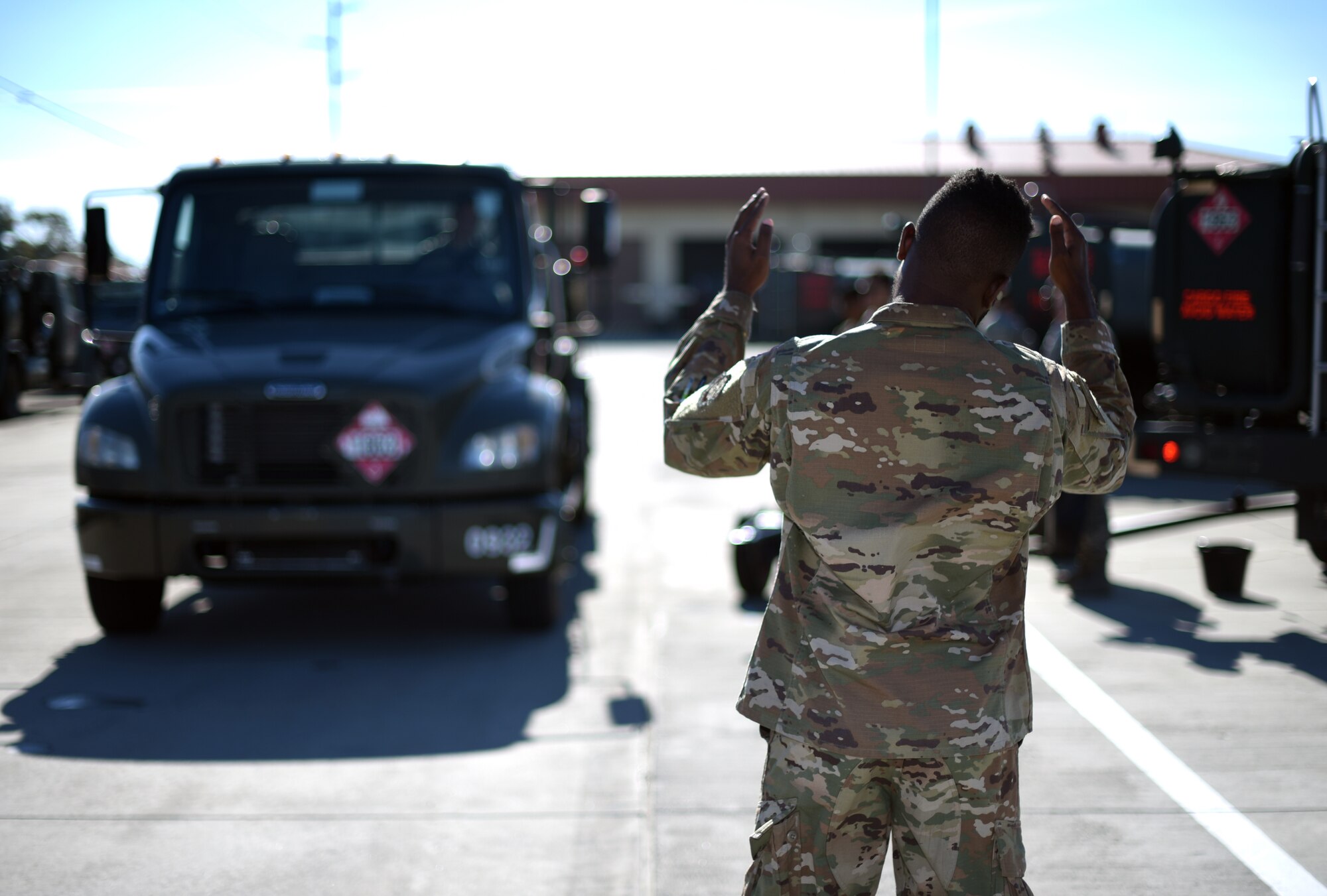 U.S. Air Force Staff Sgt. Brandon Avery, 60th Logistics Readiness Squadron fuels distribution operator, guides a 60th LRS fuel truck into a refueling depot July 10, 2019, at Travis Air Force Base, California. The 60th LRS has put forth a concerted effort to modernize their processes in recent months and have originated innovative designs that have garnered the interest of the Air Force at large. (U.S. Air Force photo by Senior Airman Christian Conrad)