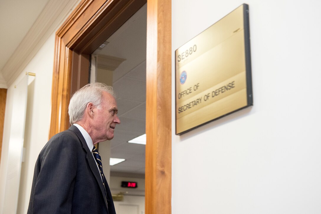 Acting Defense Secretary Richard V. Spencer walks through a doorway.