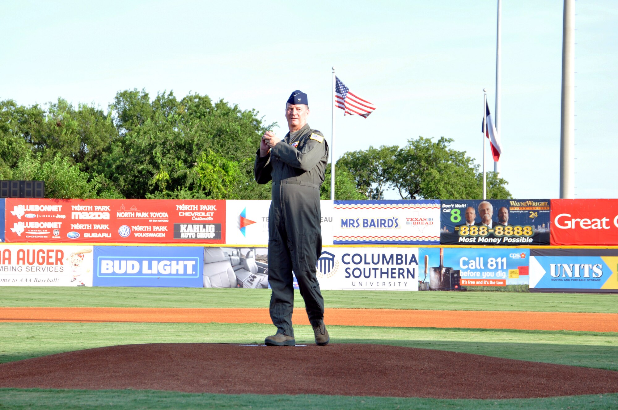 Col. Terry W. McClain, 433rd Airlift Wing commander, throws the first pitch of the game at the San Antonio Missions baseball team’s 433rd Airlift Wing Night game July 13, 2019 at Nelson W. Wolff Municipal Stadium.