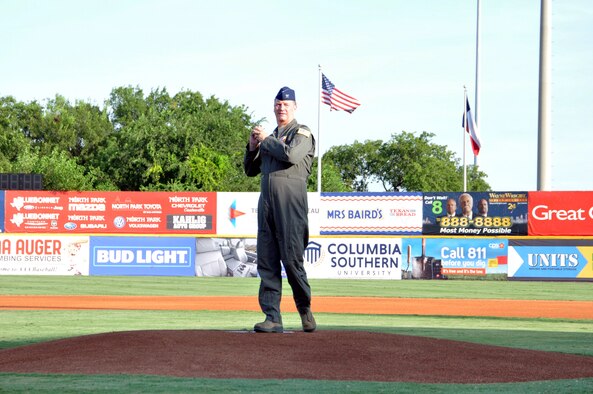Col. Terry W. McClain, 433rd Airlift Wing commander, throws the first pitch of the game at the San Antonio Missions baseball team’s 433rd Airlift Wing Night game July 13, 2019 at Nelson W. Wolff Municipal Stadium.