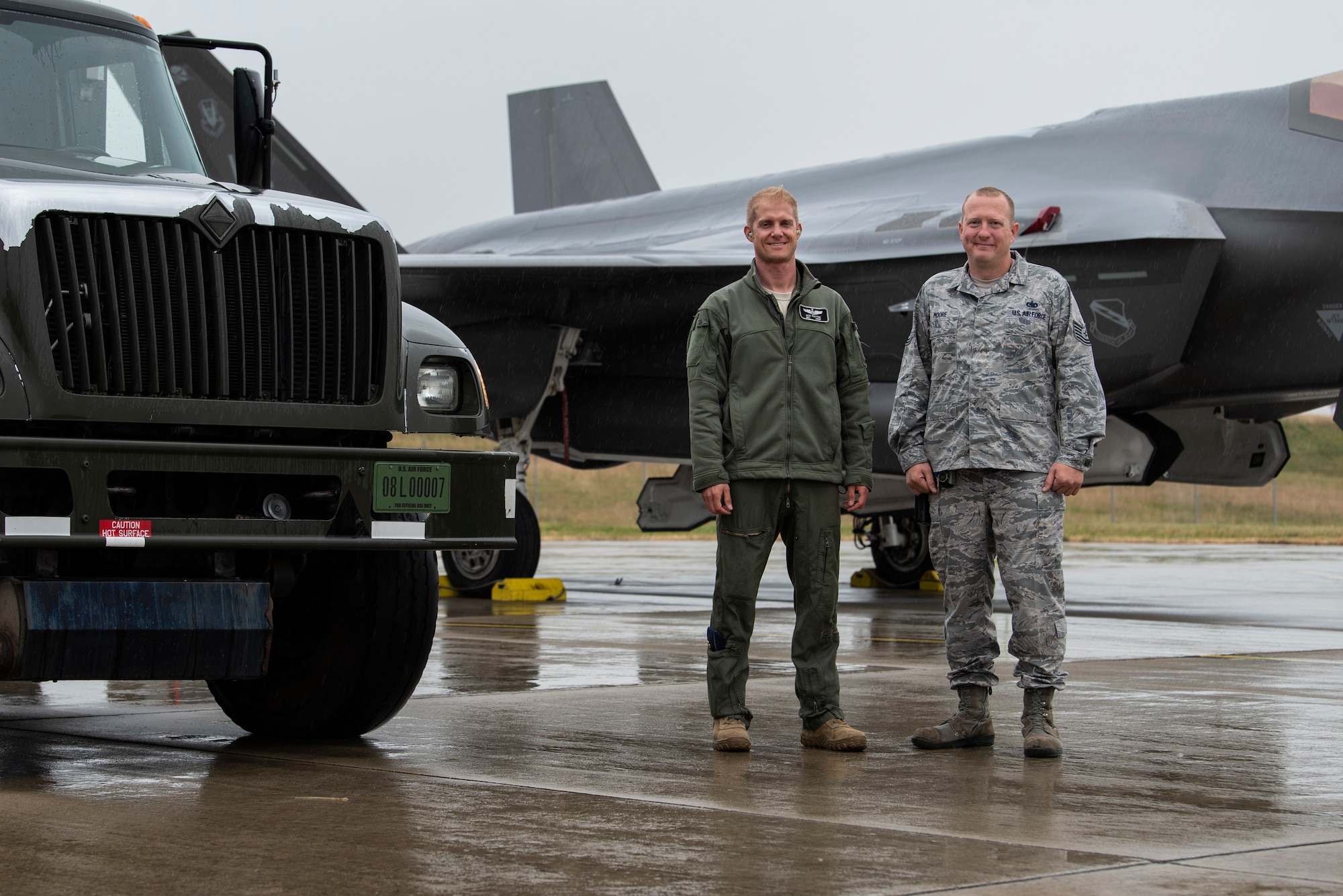 U.S. Air Force Maj. Michael Slotten, 421st Fighter Squadron F-35A Lightning II pilot, left, poses for a photo with his former shift supervisor, Tech. Sgt. Charles Moore, 52nd Logistics Readiness Squadron fuels distribution NCO in charge, right, at Spangdahlem Air Base, Germany, July 11, 2019. Slotten was stationed at Spangdahlem from 2004 to 2006 as an Airman first class fuels distributor operator. He reunited with Moore, who is currently stationed at Spangdahlem again. (U.S. Air Force photo by Airman 1st Class Valerie Seelye)