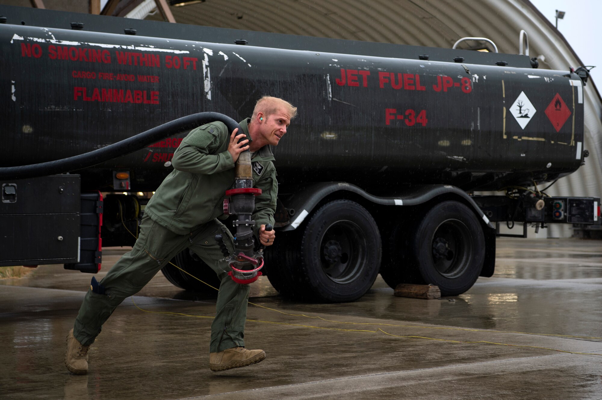 U.S. Air Force Maj. Michael Slotten, 421st Fighter Squadron F-35A Lightning II pilot, drags a fuel hose to an F-35A at Spangdahlem Air Base, Germany, July 11, 2019. Slotten was stationed at Spangdahlem from 2004 to 2006 as an Airman first class fuels distributor operator. He visited his old unit and became requalified to refuel aircraft to encourage Airmen who may want to follow in his footsteps. (U.S. Air Force photo by Airman 1st Class Valerie Seelye)