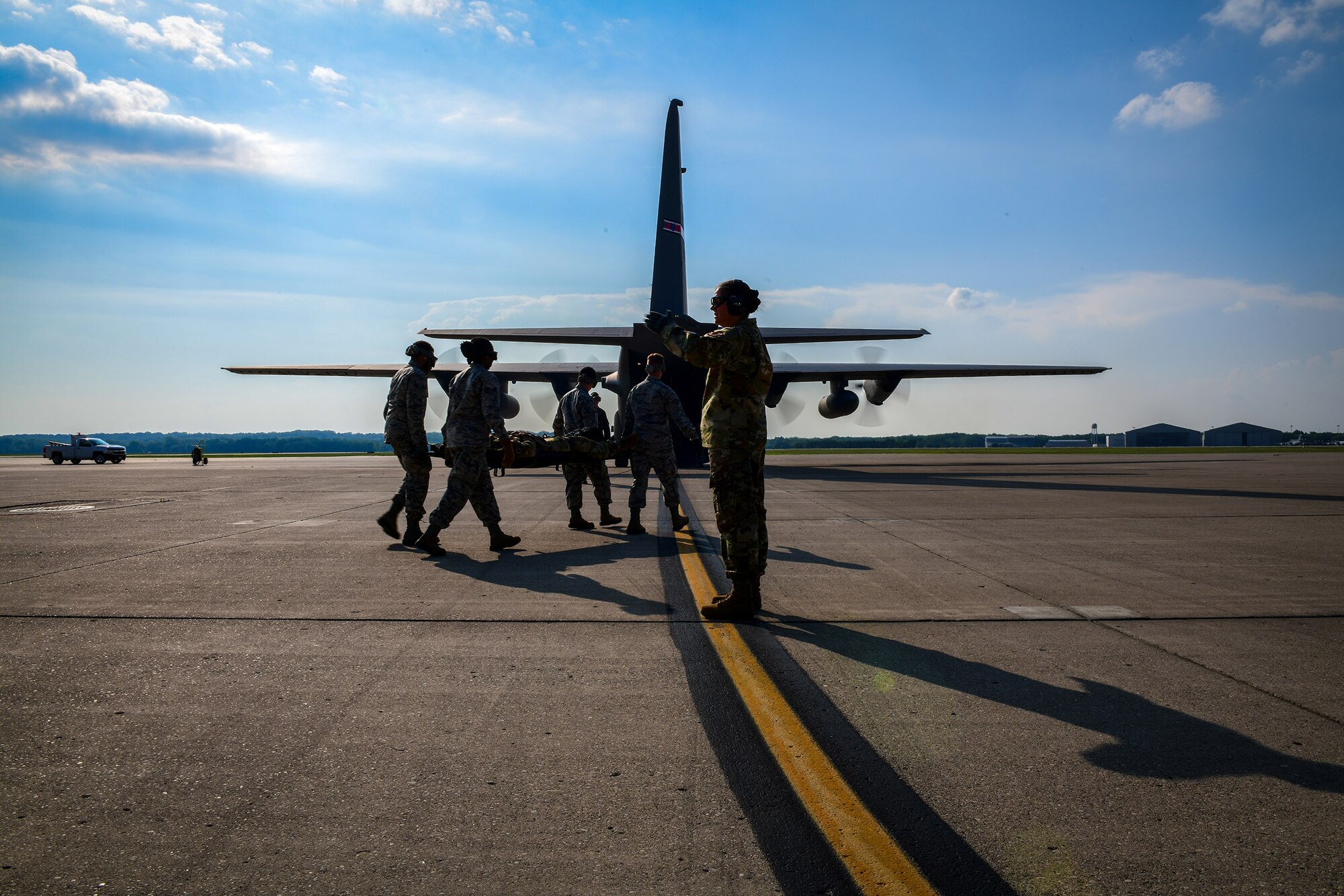 Reserve Airmen with the 445th Aeromedical Evacuation Squadron walk toward a Youngstown Air Reserve Station C-130H Hercules on the flight line at Wright-Patterson Air Force Base, Ohio, July 10, 2019. Medical personnel with the 445th AES worked as a team to conduct an aeromedical evacuation exercise using the aircraft, which was provided by YARS’ 757th Airlift Squadron. (U.S. Air Force photo by Senior Airman Christina Russo)