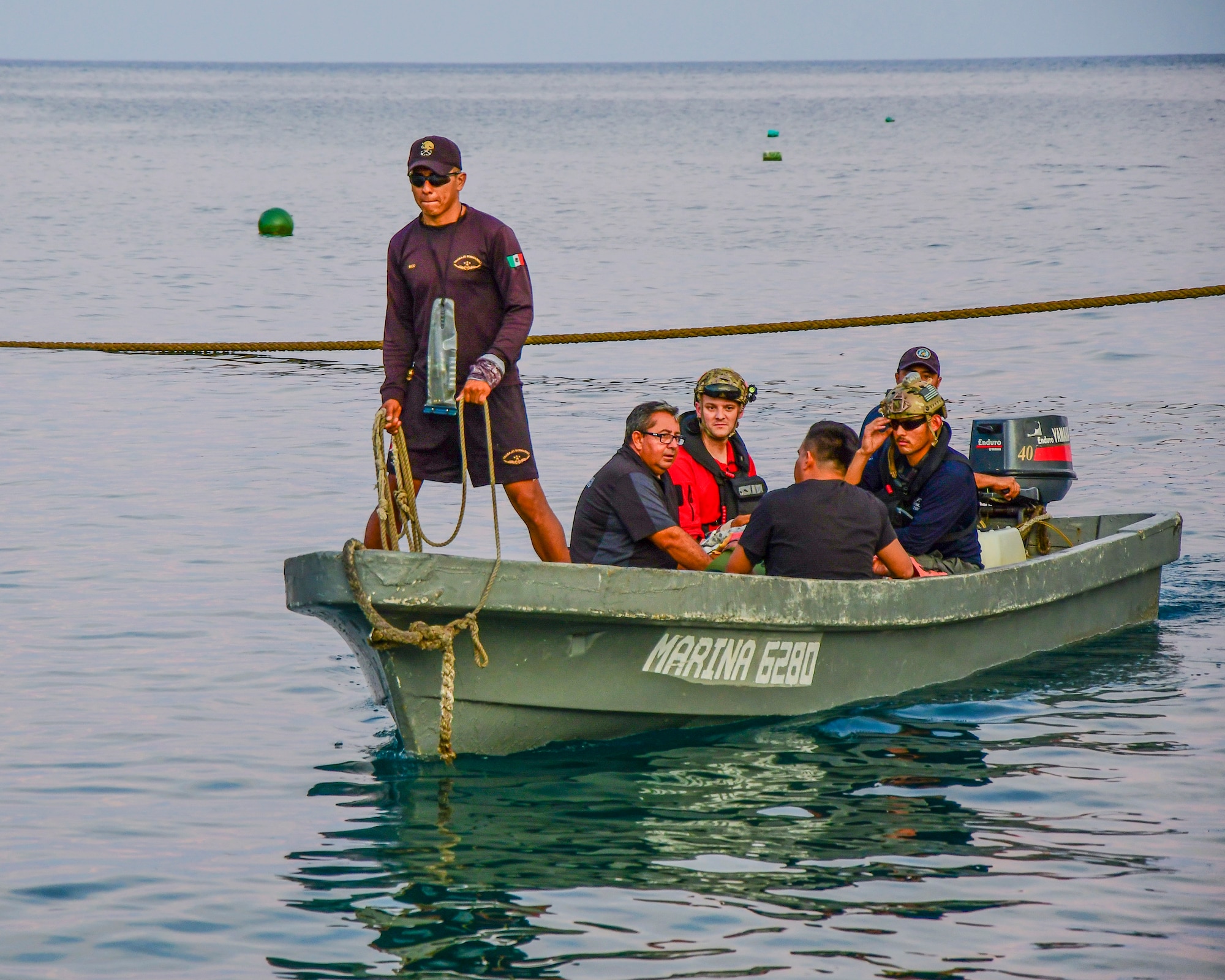 Pararescuemen from the 48th Rescue Squadron, Davis-Monthan Air Force Base, Arizona, along with injured fishermen are transported from the Tamara, a fishing vessel, to Socorro Island, Mexico, July 12, 2019. The pararescuemen cared for fishermen, who were injured when a 25-ton crane fell on them. A Travis AFB, California, KC-10 Extender refueled the HC-130J over the Pacific Ocean enabling it to make it to the Tamara. (U.S. Air Force photo by Airman 1st Class Kristine Legate)