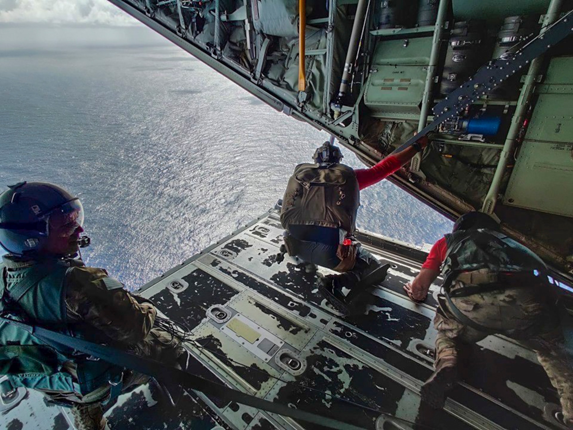 Pararescuemen from the 48th Rescue Squadron, Davis-Monthan Air Force Base, Arizona, prepare to parachute into the ocean from a HC-130J Combat King II aircraft from the 79th RQS to a Mexican fishing vessel as it sailed to Socorro Island, Mexico, July 10, 2019. The pararescuemen cared for two critically injured fishermen who were injured when a 25-ton crane fell on them. A Travis AFB, California, KC-10 Extender refueled the HC-130J over the Pacific Ocean enabling it to make it to the Tamara. (Courtesy photo)