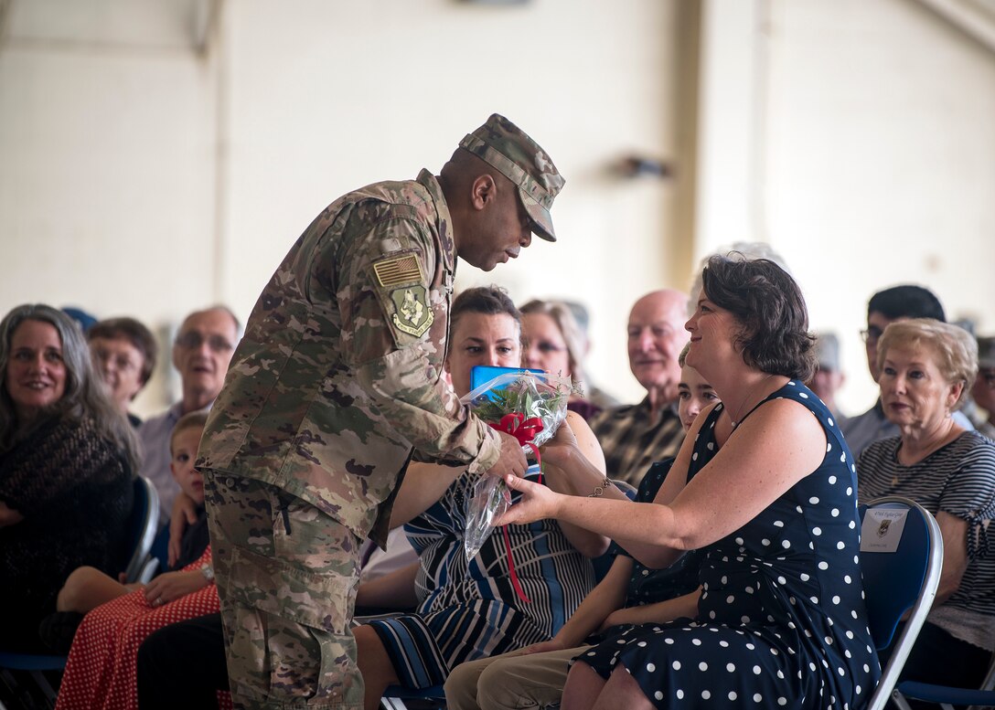 Catherine Cook, right, wife of Col. Gerald Cook, 476th Fighter Group commander, receives a bouquet of flowers during a change of command ceremony, July 14, 2019, at Moody Air Force Base, Ga. The ceremony is a military tradition that represents a formal transfer of a unit’s authority and responsibility from one commander to another. (U.S. Air Force photo by Airman 1st Class Eugene Oliver)