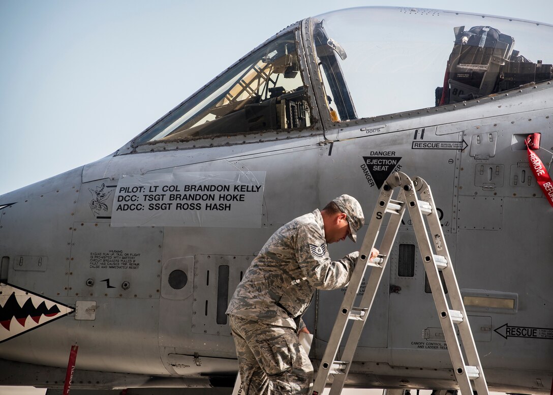 An Airman from the 476th Fighter Group (FG), climbs down a ladder following the renaming of the 476th FG flagship during a change of command ceremony, July 14, 2019, at Moody Air Force Base, Ga. The ceremony is a military tradition that represents a formal transfer of a unit’s authority and responsibility from one commander to another. (U.S. Air Force photo by Airman 1st Class Eugene Oliver)
