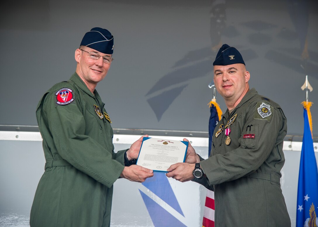 Brig. General Roger Suro, 442d Fighter Wing commander, presents the Meritorious Service Medal to Col. Gerald Cook, 476th Fighter Group commander, during a change of command ceremony, July 14, 2019, at Moody Air Force Base (AFB), Ga. The ceremony is a military tradition that represents a formal transfer of a unit’s authority and responsibility from one commander to another. Cook will depart Moody AFB to attend the National War College, Washington D.C. (U.S. Air Force photo by Airman 1st Class Eugene Oliver)