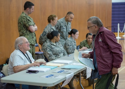 Patient administrators with the Greater Chenango Care Innovative Readiness Training check-in patients July 15, 2019, at Norwich High School, Norwich, New York.