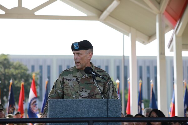 A military leader speaks at a podium.
