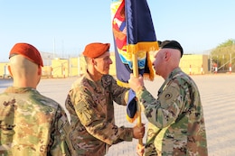U.S. Army Col. Mark P. Ott, the outgoing commander of Task Force Sinai (TFS), passes the TFS colors to Maj. Gen. John P. Sullivan, commander of the 1st Theater Sustainment Command, during a change of command ceremony at South Camp, Egypt, July 15, 2019.
