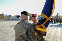 U.S. Army Maj. Gen. John P. Sullivan, commander of the 1st Theater Sustainment Command, passes the Task Force Sinai (TFS) colors to Col. Robert J. Duchaine, the incoming commander of TFS, during a change of command ceremony at South Camp, Egypt, July 15, 2019.