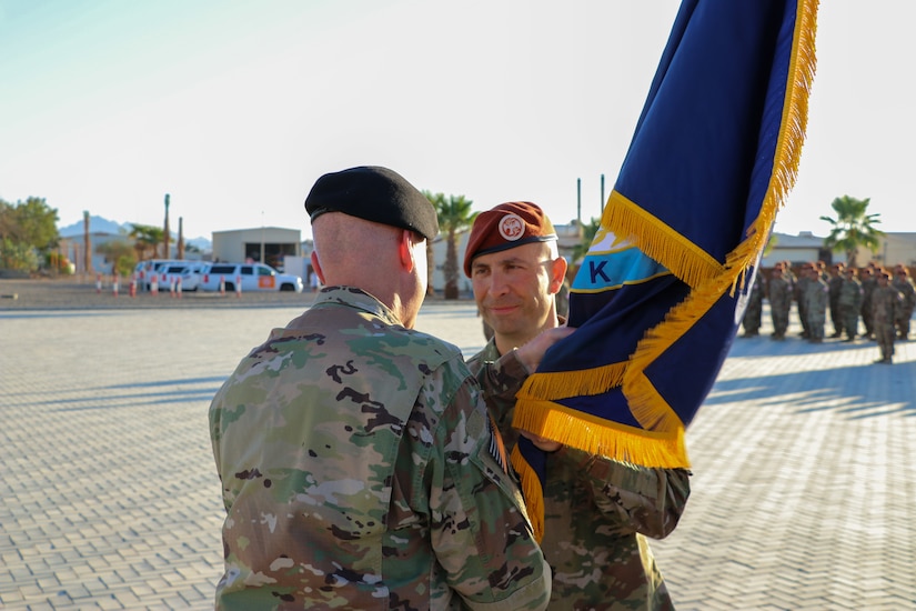 U.S. Army Maj. Gen. John P. Sullivan, commander of the 1st Theater Sustainment Command, passes the Task Force Sinai (TFS) colors to Col. Robert J. Duchaine, the incoming commander of TFS, during a change of command ceremony at South Camp, Egypt, July 15, 2019.