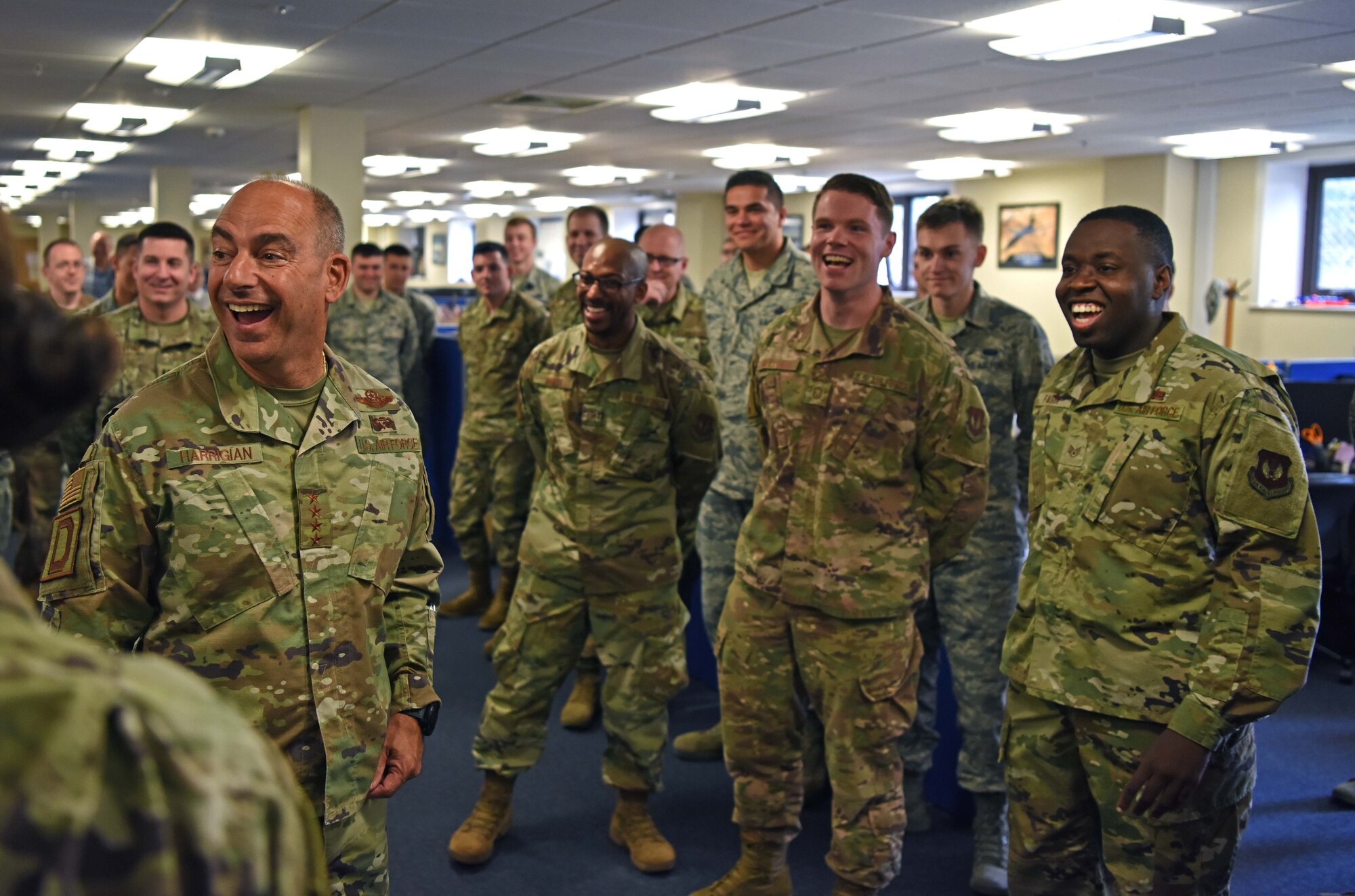U.S. Air Force Gen. Jeff Harrigian, U.S. Air Forces in Europe – Air Forces Africa commander, shares a laugh with members of the 100th Communications Squadron during his visit to RAF Mildenhall, England, July 15, 2019. During the visit, Harrigian introduced his three priorities as USAFE-AFAFRICA commander – readiness, posture and partnerships. (U.S. Air Force photo by Airman 1st Class Brandon Esau)