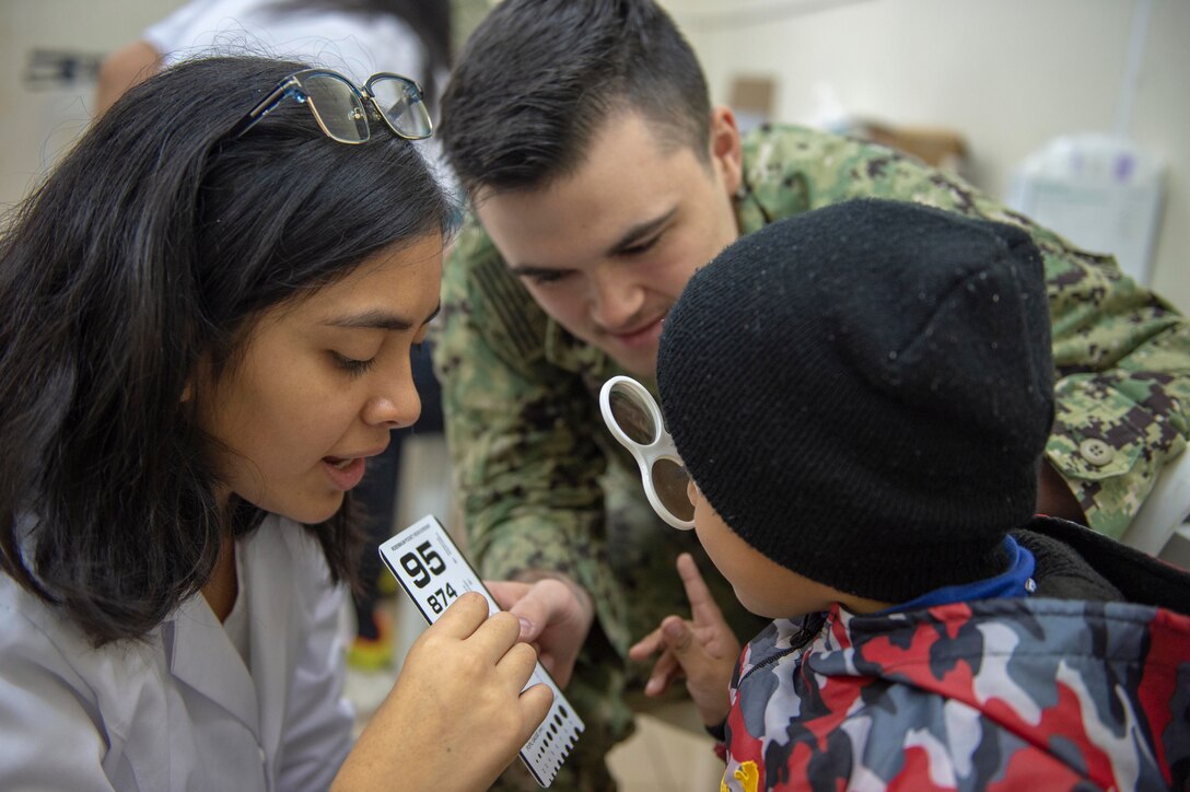 A doctor conducts an eye exam.