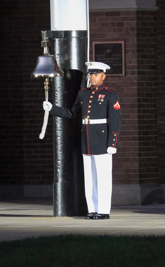 A Marine with Marine Barracks Washington D.C. rings the ceremonial bell during a Friday Evening Parade at Marine Barracks Washington D.C., July 12, 2019. Lieutenant Gen. John M. Jansen, deputy commandant, Programs and Resources, was the hosting official and His Excellency Shinsuke J. Sugiyama, Ambassador Extraordinary and Plenipotentiary to the United States from Japan and Minister Patrick Chuasoto, Deputy Chief of Mission from the United Kingdom of the Philippines to the United States were the guests of honor for the evening.