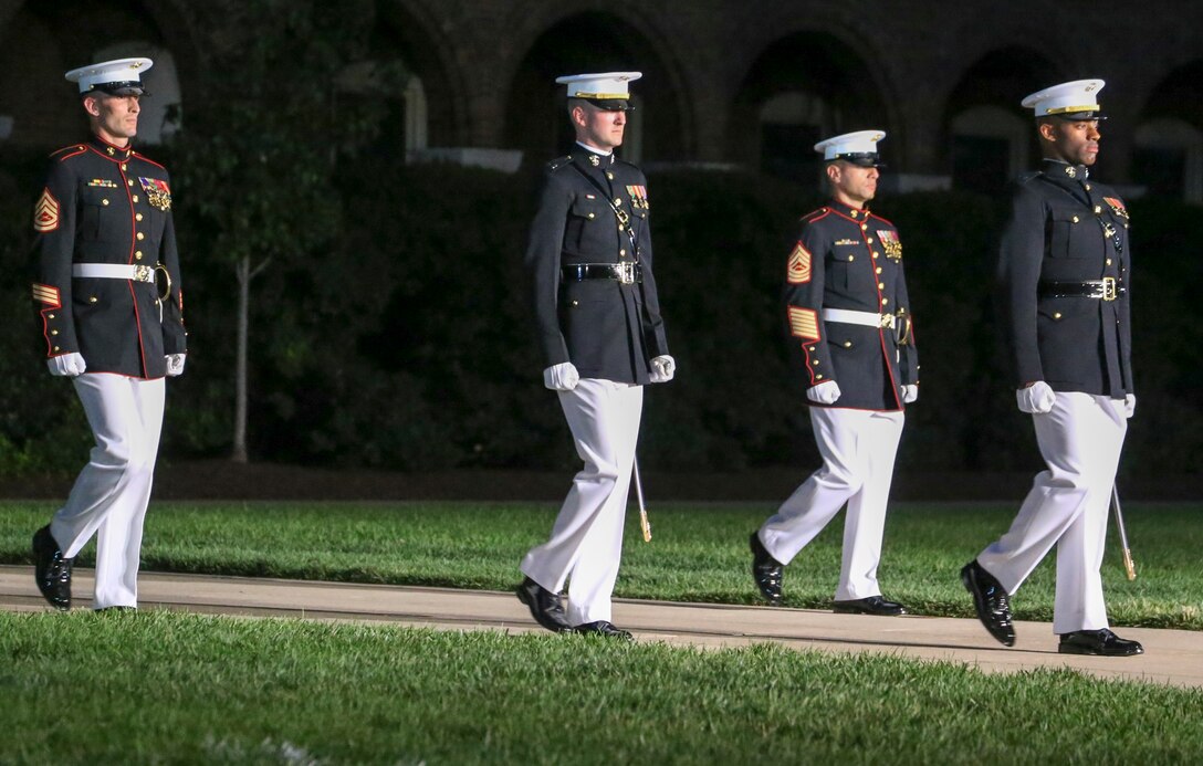 Marines with Marine Barracks Washington D.C. parade marching staff march down Center Walk during a Friday Evening Parade at Marine Barracks Washington D.C., July 12, 2019. Lieutenant Gen. John M. Jansen, deputy commandant, Programs and Resources, was the hosting official and His Excellency Shinsuke J. Sugiyama, Ambassador Extraordinary and Plenipotentiary to the United States from Japan and Minister Patrick Chuasoto, Deputy Chief of Mission from the United Kingdom of the Philippines to the United States were the guests of honor for the evening.