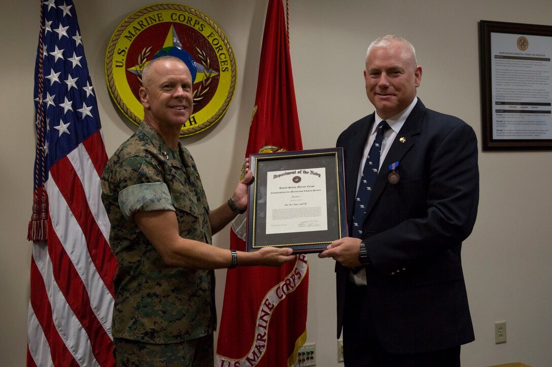 Robert Andrew was awarded the Navy-Civilian Meritorious Service Medal after spending his last two years at U.S. Marine Corps Forces, South as the political advisor, July 11, 2019.