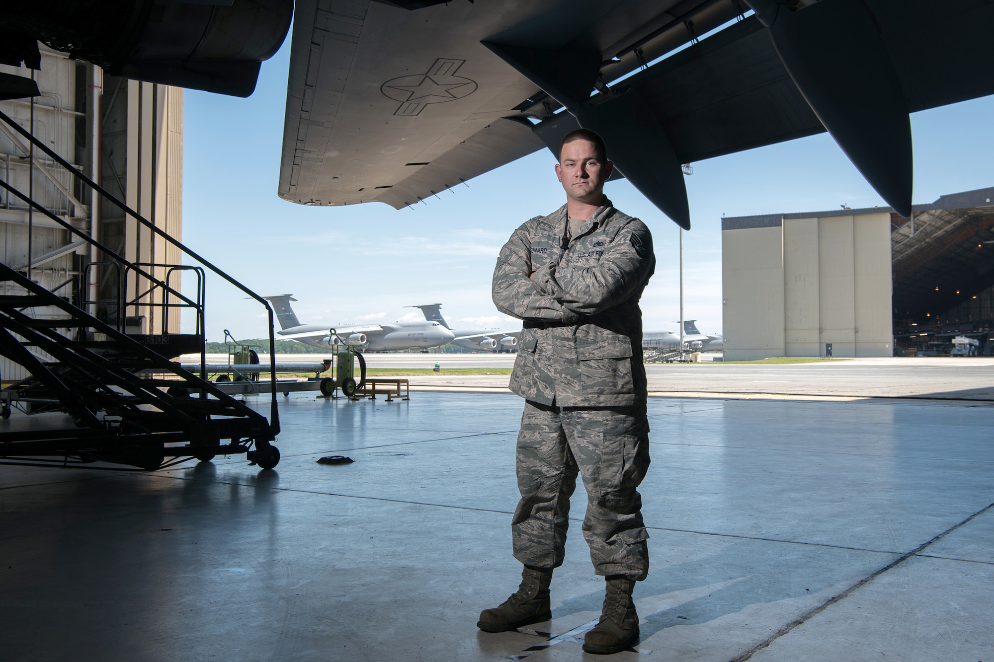 Staff Sgt. Lawrence Leonard, 736th Aerial Maintenance Squadron propulsion systems craftsman, stands underneath the wing of a C-17 Globemaster III June 26, 2019, at Dover Air Force Base, Del. Certain maintenance is performed inside a hangar to protect aircraft components from inclement weather. (U.S. Air Force photo by Mauricio Campino)