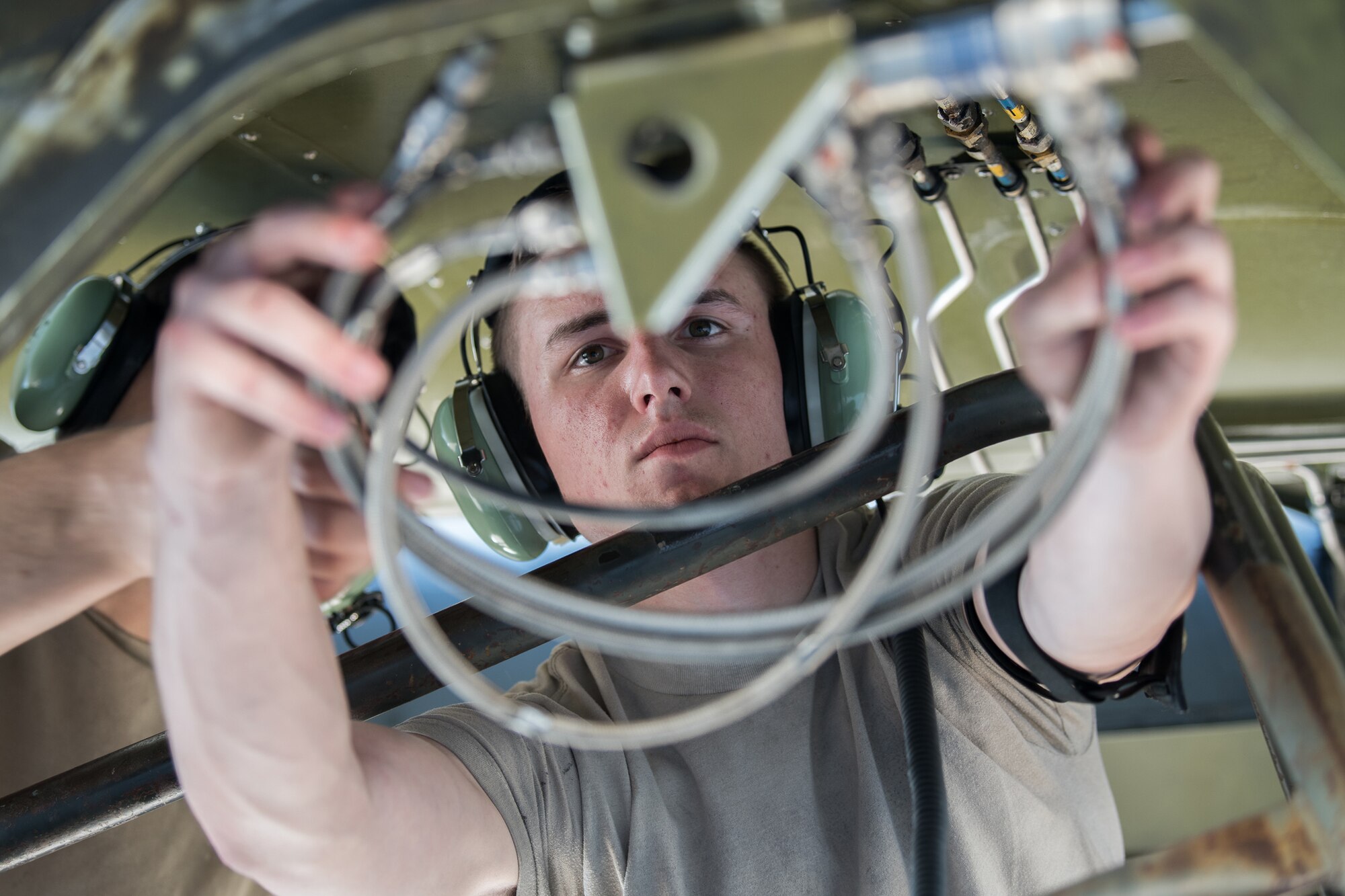 Airman 1st Class Wyatt Robinson, 436th Maintenance Squadron aircraft hydraulics specialist, identifies a leaky hydraulic line on a C-17 Globemaster III June 27, 2019, at Dover Air Force Base, Del. Robinson replaced the faulty line after confirming the new part was the correct length. (U.S. Air Force photo by Mauricio Campino)