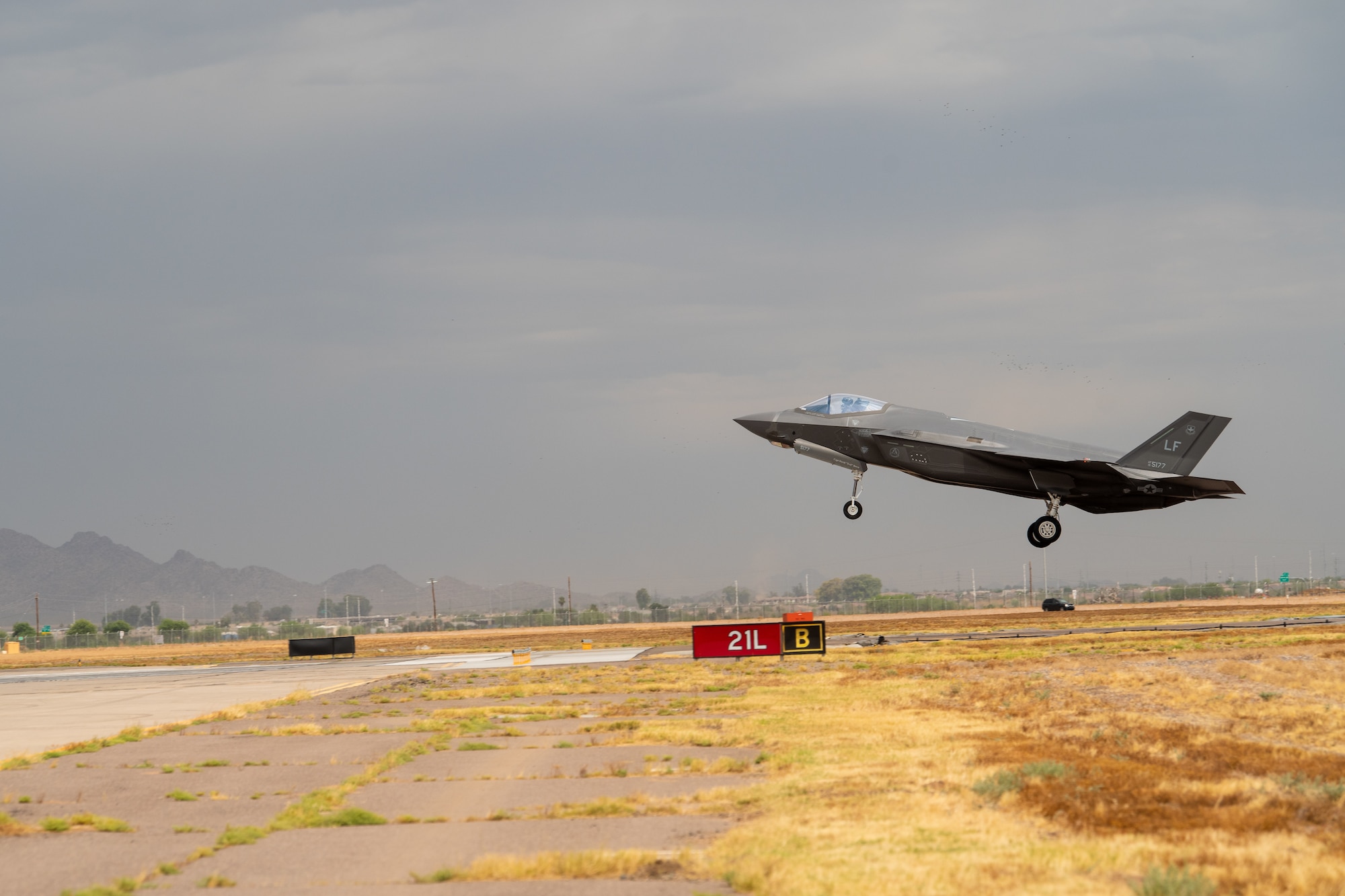 An F-35A Lightning II assigned to the 63rd Fighter Squadron lands during a storm July 12, 2019, at Luke Air Force Base, Ariz. Every summer, Luke combats monsoon season, which consist of torrential downpours and sandstorms making it one of the harshest training environments in the United States. (U.S. Air Force photo by Airman 1st Class Aspen Reid)