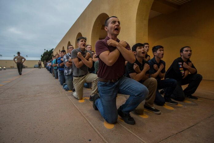 New recruits with Kilo Company, 3rd Recruit training Battalion respond to a drill instructor during a Uniform Code of Military Justice brief at Marine Corps Recruit Depot San Diego, July 8.