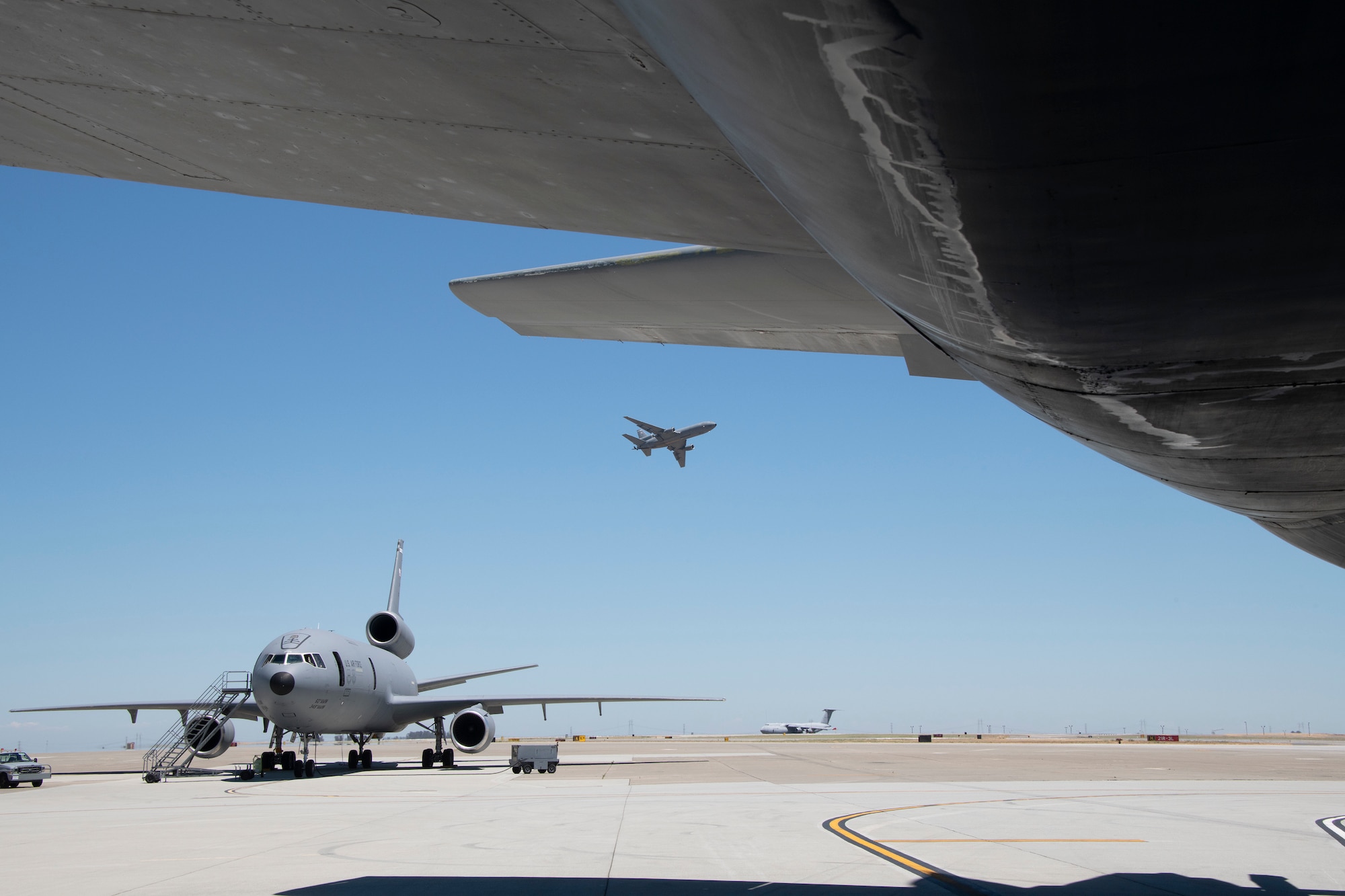 U.S. Air Force KC-10 Extender rests on the flight line July 11, 2019 at Travis Air Force Base, California. Although the KC-l0’s primary mission is aerial refueling, it can combine the tasks of a tanker and cargo aircraft by refueling fighters while simultaneously carrying support personnel and equipment. (U.S. Air Force photo by Heide Couch)