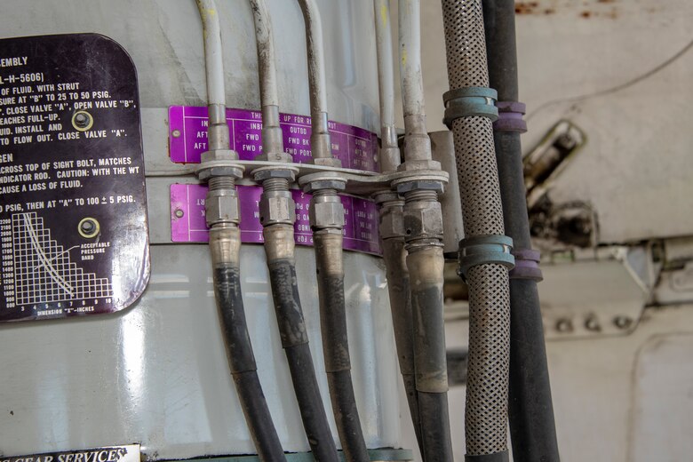 A KC-10 Extender landing strut is serviced by ground maintenance, July 11, 2019, at Travis Air Force Base, California. Although the KC-l0’s primary mission is aerial refueling, it can combine the tasks of a tanker and cargo aircraft by refueling fighters while simultaneously carrying support personnel and equipment.(U.S. Air Force photo by Heide Couch)