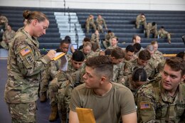 Sgt. 1st Class Kerrilee Case signs as a witness on a cadet’s bone marrow donor registration form during the American Red Cross’s Cadet Summer Training Blood Drive held July 12, 2019 at Smith Fitness Center on Fort Knox, Ky.