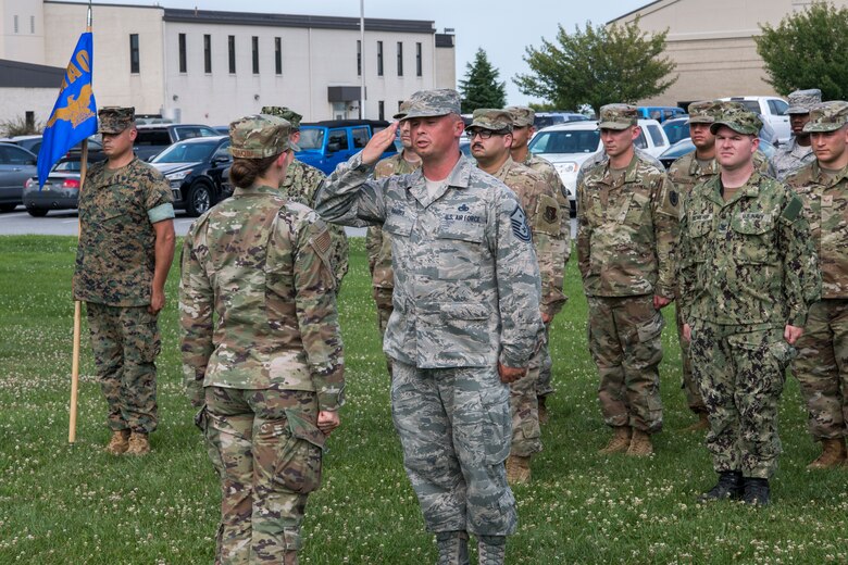 Master Sgt. Justin Hammer, Air Force Mortuary Affairs Operations (AFMAO) first sergeant, salutes Capt. Shelby Yoakum, AFMAO executive officer, at the start of the retreat ceremony July 11, 2019, at Dover Air Force Base, Del. The ceremony is one of the oldest military traditions, dating all the way back to the Revolutionary War. (U.S. Air Force photo by Senior Airman Christopher Quail)