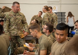 Sgt. 1st Class Scotty Case assists a cadet with filling out his bone marrow donor consent form during the American Red Cross’s Cadet Summer Training Blood Drive held July 12, 2019 at Smith Fitness Center at Fort Knox, Ky.