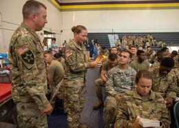 Sgt. 1st Class Kerrilee Case collects a bone marrow donor kit as Sgt. 1st Class Scotty Case looks on during the American Red Cross’s Cadet Summer Training Blood Drive held July 12, 2019 at Smith Fitness Center at Fort Knox, Ky.
