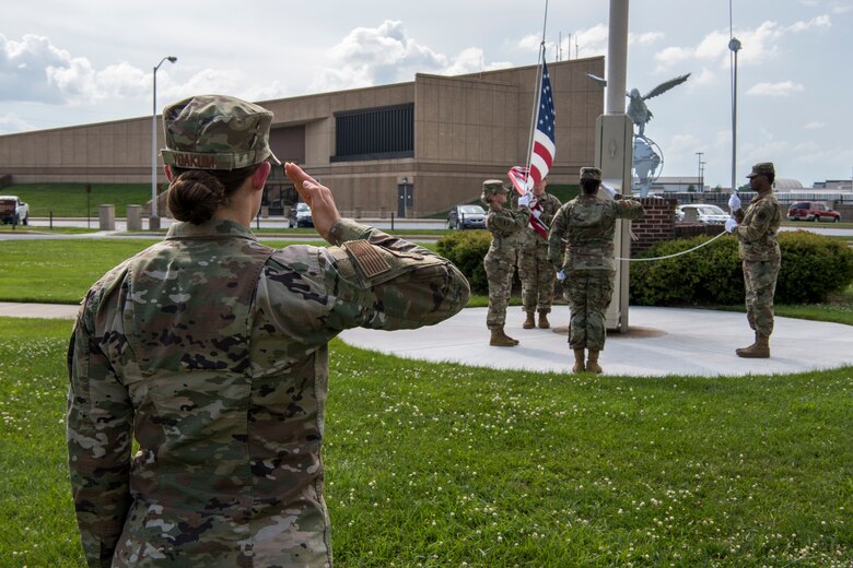 Capt. Shelby Yoakum, Air Force Mortuary Affairs Operations executive officer, salutes the U.S. flag during the retreat ceremony July 11, 2019, at Dover Air Force Base, Del. The salute is a gesture that is used to display respect. (U.S. Air Force photo by Senior Airman Christopher Quail)