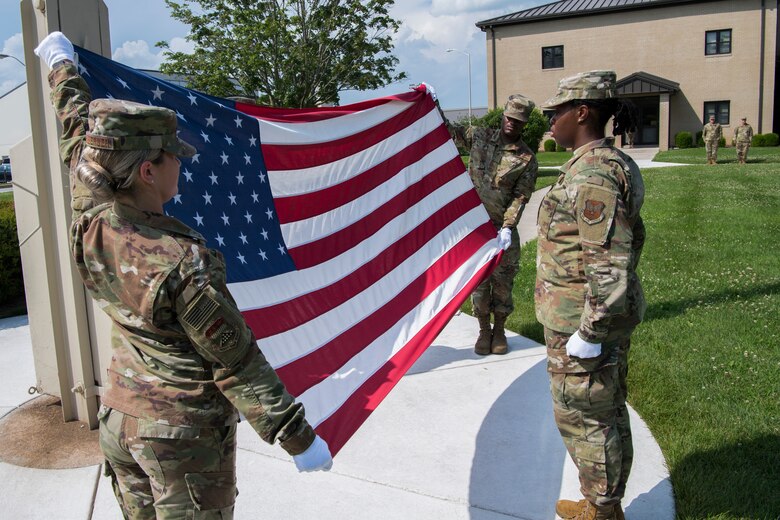 Members of the Air Force Mortuary Affairs Operations conduct a retreat ceremony July 11, 2019, at Dover Air Force Base, Del. During the ceremony, all base personnel outside are to stop and honor the flag. (U.S. Air Force photo by Senior Airman Christopher Quail)