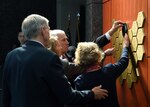 The family of Scott Wirtz removed the black cloth uncovering his name plaque, memorialized on the DIA Patriots Memorial wall.