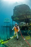 David Coan, extra vehicular activity lead for the National Aeronautics and Space Administration (NASA) Johnson Space Center dives at the Aquarius Reef Base underwater habitat.donning a Kirby Morgan-37 helmet equipped with the Divers Augmented Vision Device Generation 1.0 heads-up display during the 23rd NASA Extreme Environment Mission Operations in June 2019.