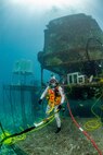David Coan, extra vehicular activity lead for the National Aeronautics and Space Administration (NASA) Johnson Space Center dives at the Aquarius Reef Base underwater habitat.donning a Kirby Morgan-37 helmet equipped with the Divers Augmented Vision Device Generation 1.0 heads-up display during the 23rd NASA Extreme Environment Mission Operations in June 2019.