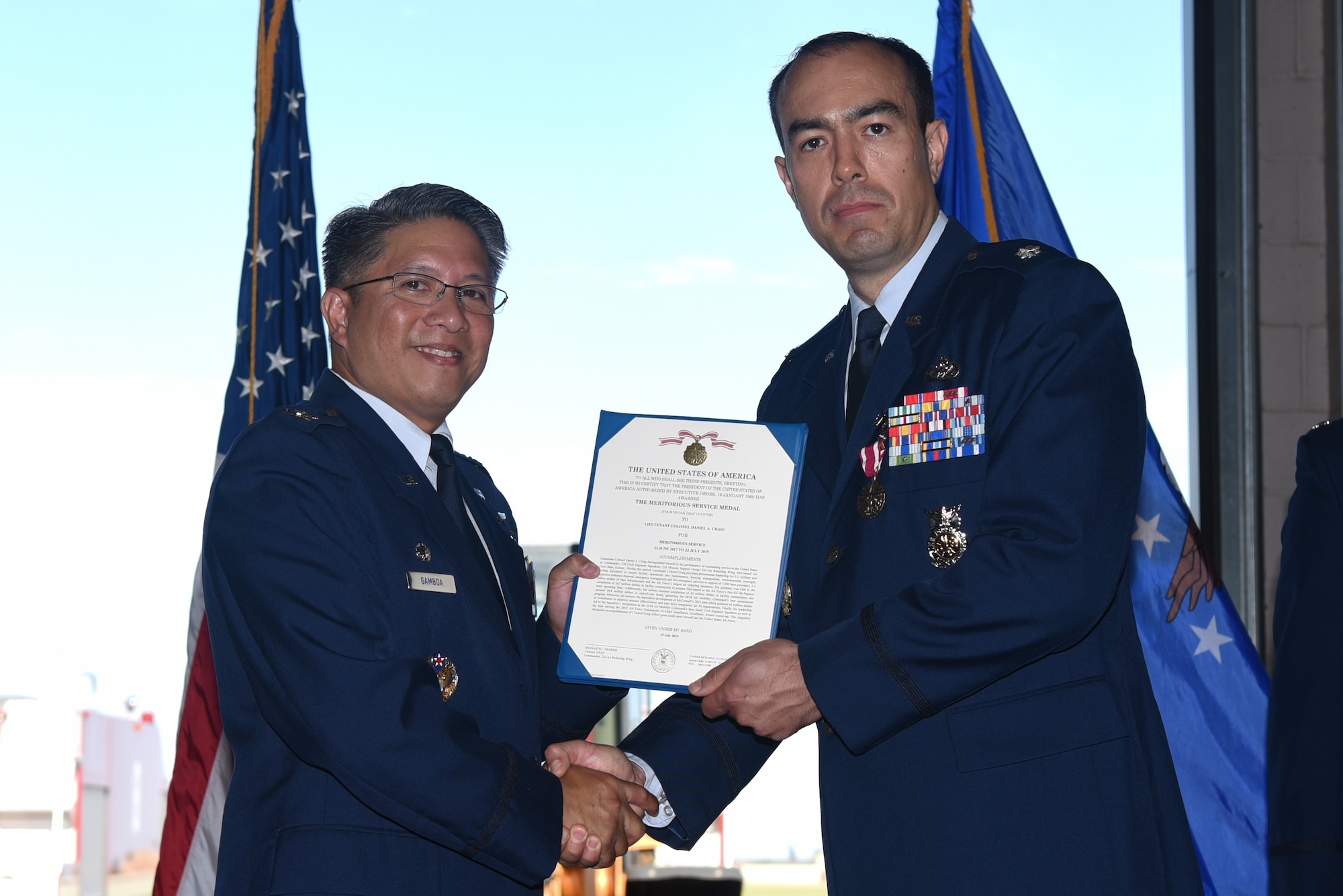Col. Anthony Gamboa, 22nd Mission Support Group commander, presents the Meritorious Service Medal to Lt. Col. Daniel Craig, outgoing 22nd Civil Engineering Squadron commander, during a change of command ceremony July 16, 2019, at McConnell Air Force Base, Kan. The medal was awarded for Craig’s outstanding meritorious conduct in the performance of exceptional services during his time at McConnell. (U.S. Air Force photo by Airman 1st Class Alexi Myrick)