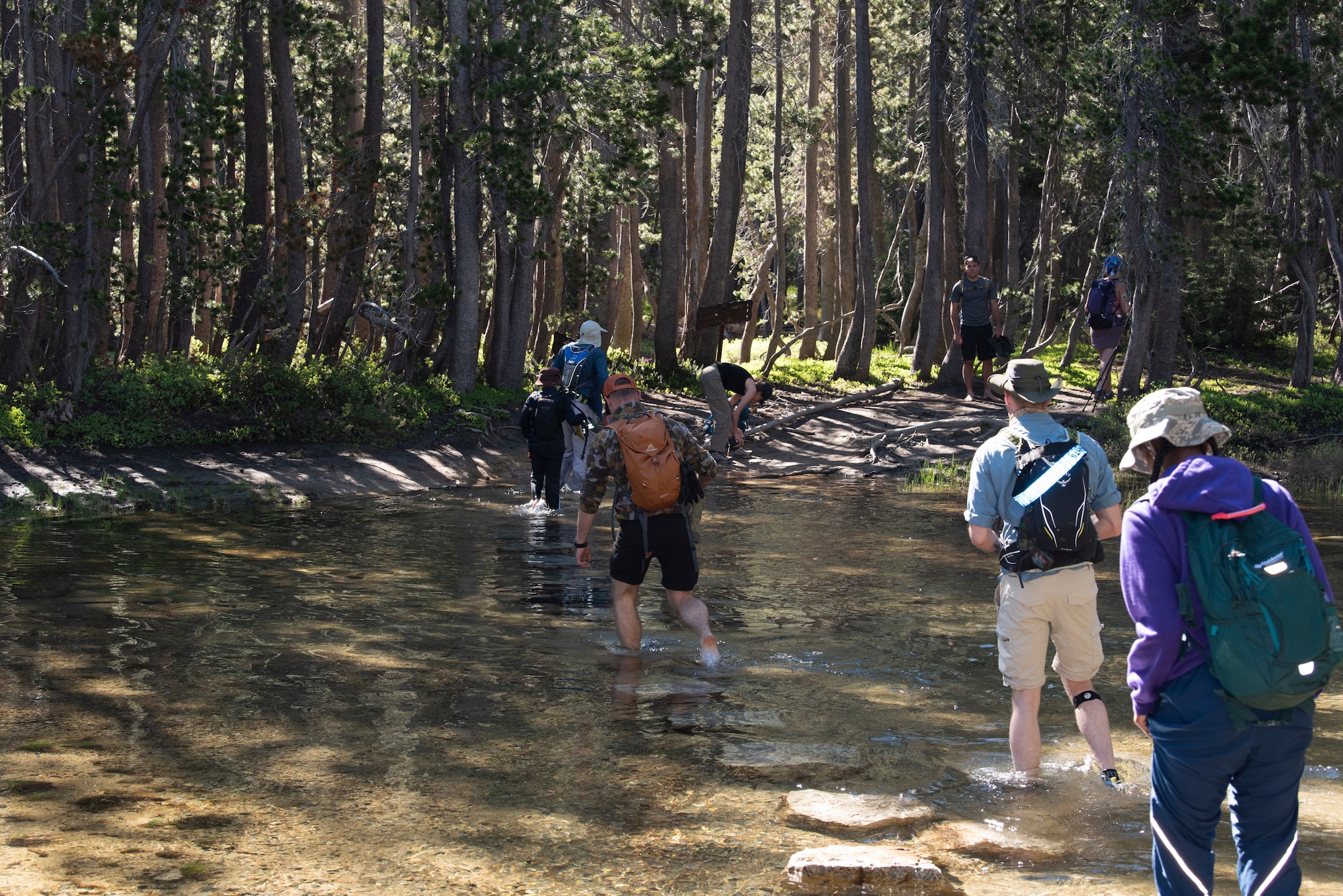 U.S. Air Force Airmen from Travis Air Force Base, California, cross a river during a resilience hike July 13, 2019, Yosemite National Park, California. The Airmen hiked to Cloud’s Rest covering 14.57 miles as they climbed to 9,926 feet above sea level. The hike was organized to enhance the Airmen’s physical, mental and spiritual resiliency. (U.S. Air Fore photo by Tech. Sgt. James Hodgman)