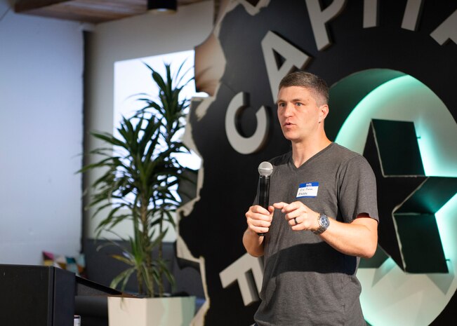 Lt. Col. Eric Frahm, director of Air Education and Training Command’s Technology Integration Detachment, speaks during the Project NEXUS kickoff event at the AFWERX Austin Hub July 8, 2019. The AETC beta test is aimed at learning the best ways to introduce more technologically ready Airmen into units. NEXUS is expected to fuel organic technology problem solving efforts for Airmen in their day-to-day workplaces. (U.S. Air Force photo by Staff Sgt. Jordyn Fetter)
