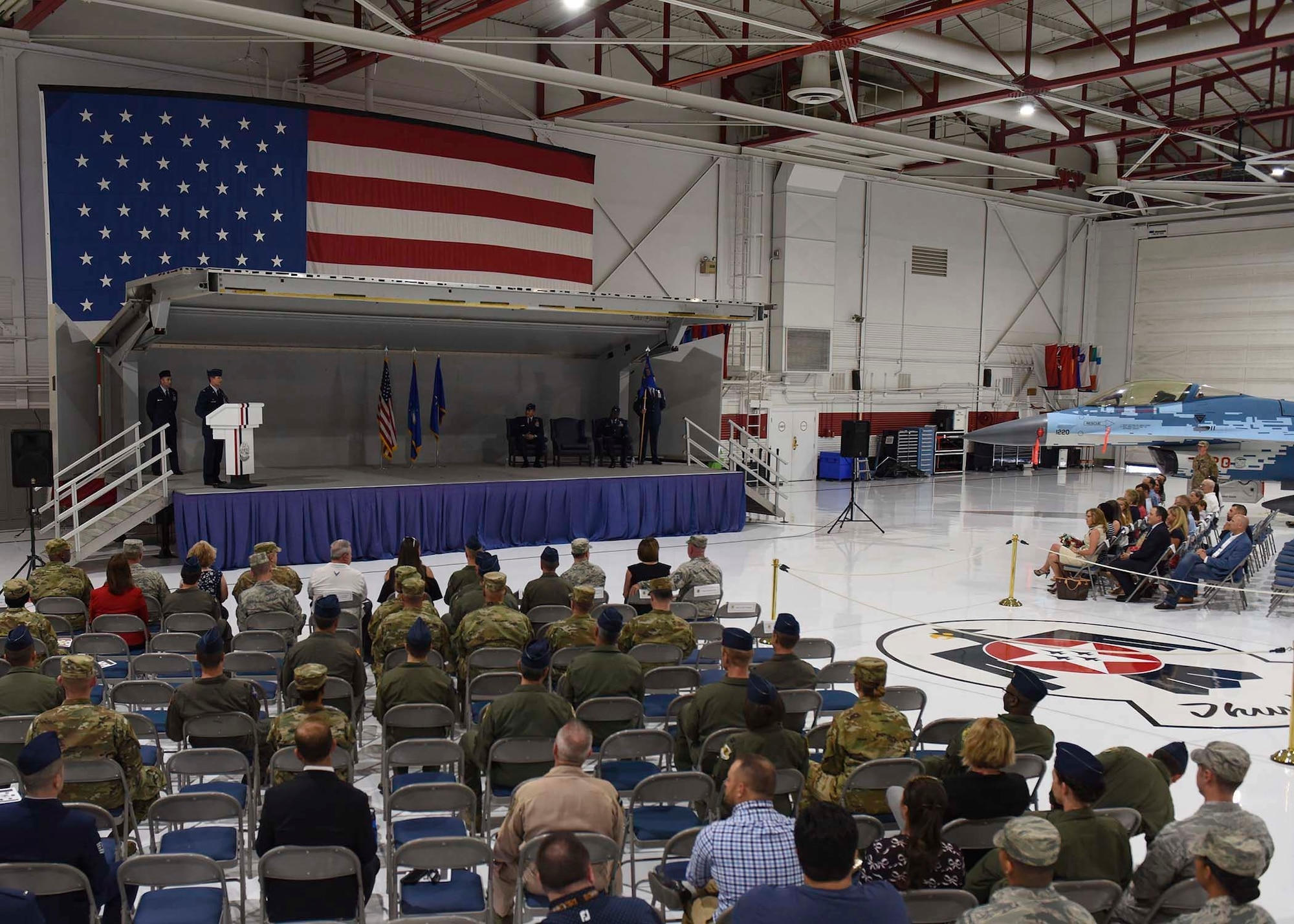 An Airman speaks to a crowd of people .