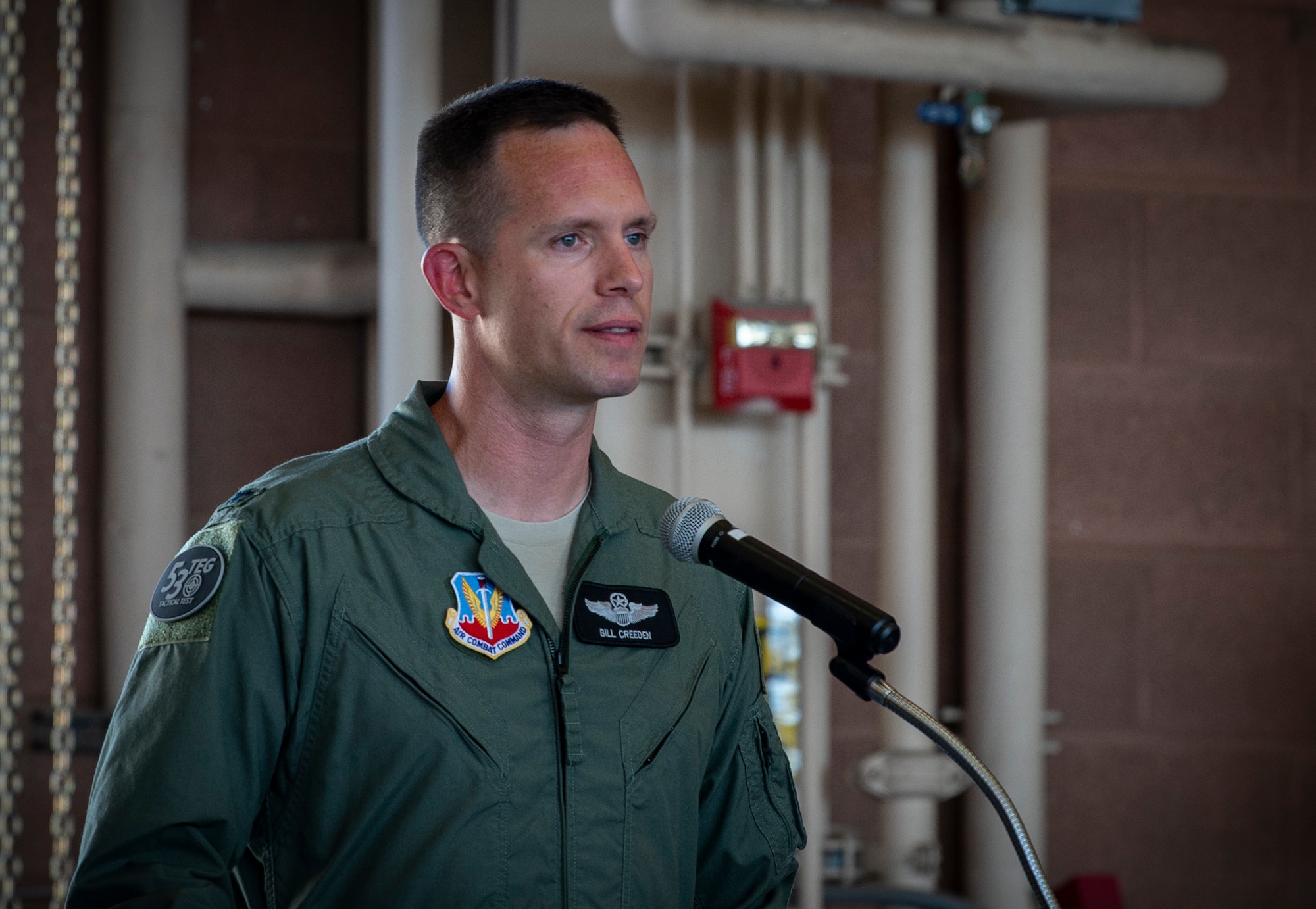 An Airman speaks at a podium.