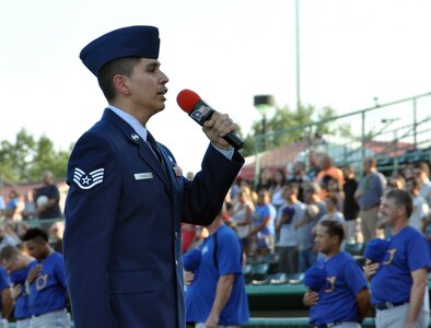 Staff Sgt. Joshua A. Ramos, 433rd Airlift Wing command post controller, sings the “The Star Spangled Banner” at the San Antonio Missions baseball team’s 433rd Airlift Wing Night game at Nelson W. Wolff Municipal Stadium July 13.
