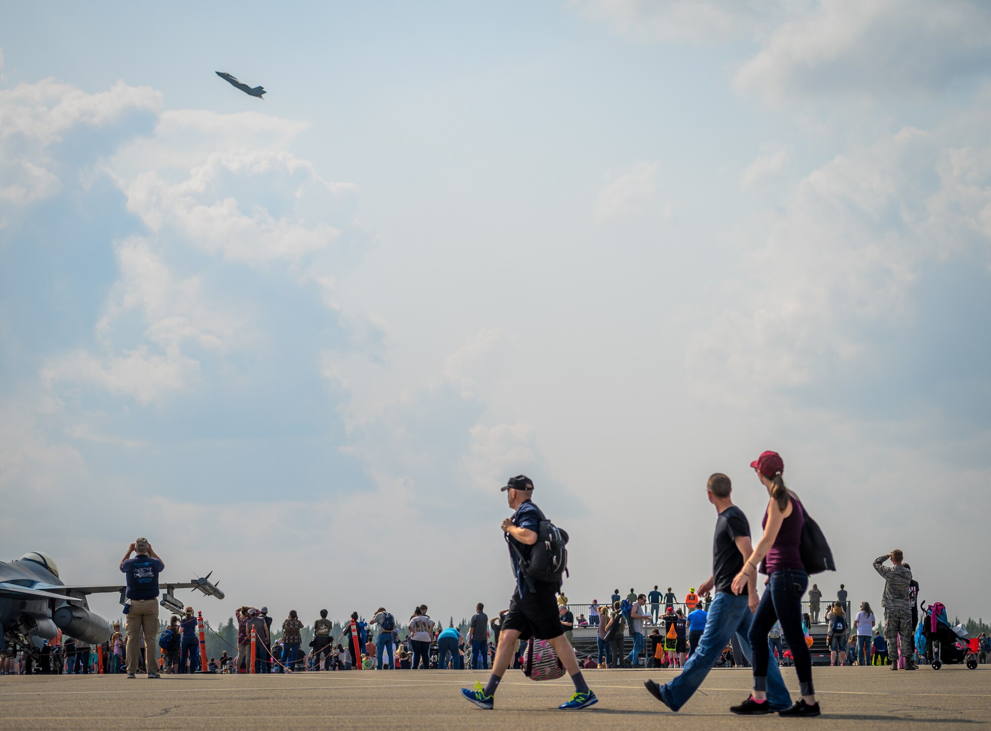 Airshow guests watch the F-35 Demonstration Team’s aerial performance during the Arctic Lightning Airshow July 13, 2019, at Eielson Air Force Base, Alaska. During the one-day event, more than 13,000 people attended the airshow. (U.S. Air Force photo by Senior Airman Alexander Cook)