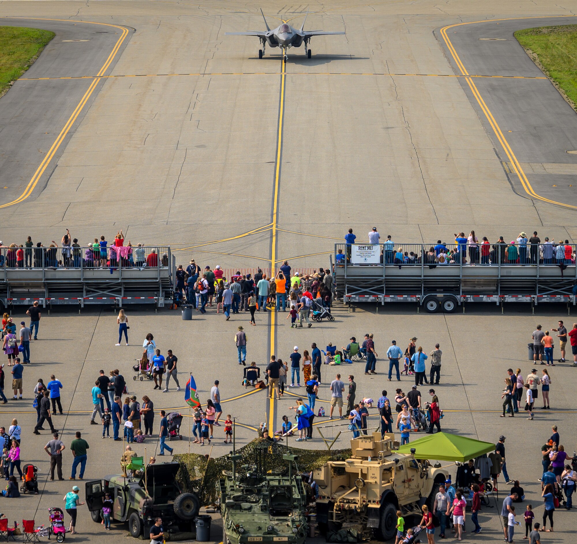 Airshow guests watch an F-35A Lightning II taxi down the runway following an aerial performance during the Arctic Lightning Airshow July 13, 2019, at Eielson Air Force Base, Alaska. Spectators got an up-close look at the Air Force’s newest fighter jet marking the airshow since 2008. (U.S. Air Force photo by Senior Airman Alexander Cook)