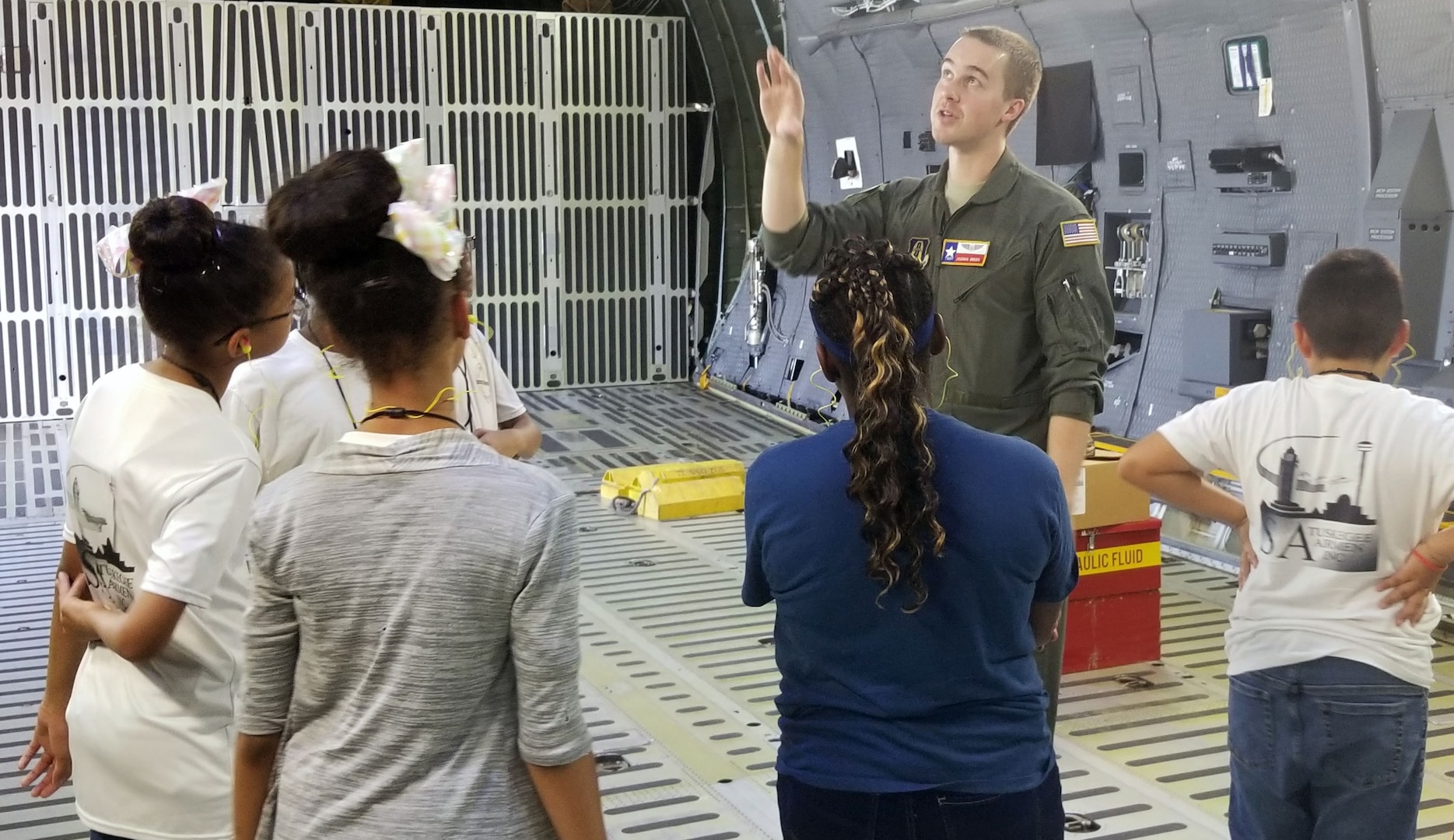 Tech. Sgt. Joshua Green, 356th Airlift Squadron loadmaster, describes the C-5M Super Galaxy’s cargo compartment to students with the San Antonio Chapter of Tuskegee Airmen Inc.’s Youth Science, Technology, Engineering and Mathematics-Aviation Program at Joint Base San Antonio-Lackland July 12.