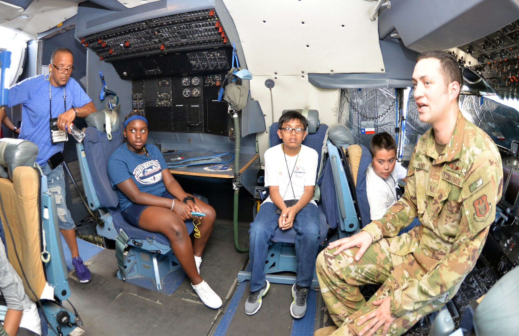 Tech. Sgt. Jason Henry, 356th Airlift Squadron flight engineer, talks to students with the San Antonio Chapter of Tuskegee Airmen Inc.’s Youth Science, Technology, Engineering and Mathematics Aviation Program about the C-5M Super Galaxy’s flight deck at Joint Base San Antonio-Lackland July 12.